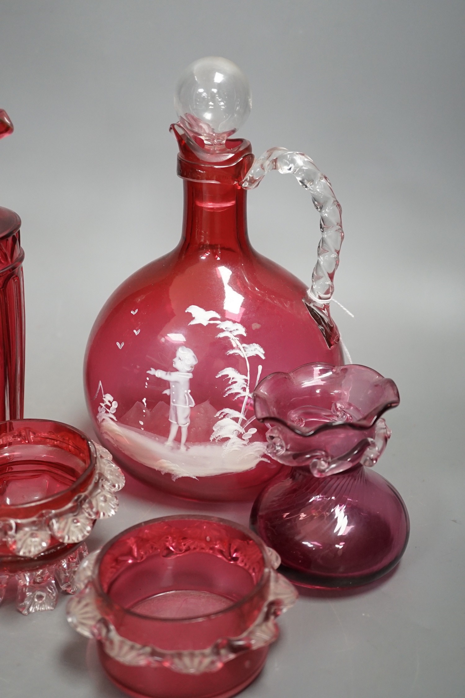 A Mary Gregory style cranberry decanter together with mixed cranberry glass (10), Mary Gregory decanter 25cms high including stopper